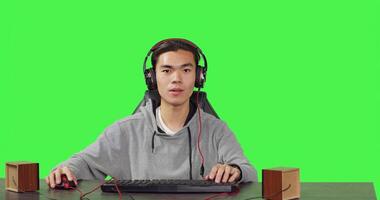 POV of man enjoying games at pc while he talks to his friends on headphones, playing computer action game at his workstation desk. Young gamer having fun with gameplay. photo