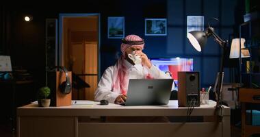 Arabic job candidate remotely being interviewed by HR worker while at home. Middle Eastern man getting his credentials checked during online conference meeting before being employed photo