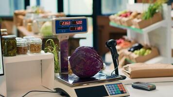 Electronic scale in zero waste eco store used to weight organic produce created without industrial solvents or synthetic food additives. Weighing machine in local grocery supermarket. photo