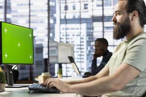 Smiling programmer using isolated screen PC to create machine learning models that can process data to automate decision making processes. Happy IT specialist programming using mockup computer photo