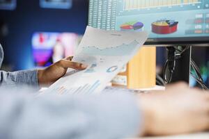 African american consultant studying constitutional balance records and expenditure figures for regular accounting evaluation. Financial expert reviews business budgetary constraints. Close up. photo