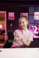 Gen Z media star filming about best virtual reality headset launched this year. Kid tech content creator recording VR goggles device review, assessing build quality and performance photo