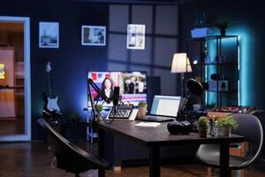 Vacant room with podcast equipment to record talk show at home. There are no people in the living room, used for online vlogging and broadcasting discussions using a microphone and sound production. photo