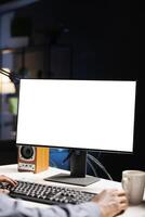 African american man staring at white screen on computer, working from home with blank empty copyspace display. Male web programmer looks at isolated chromakey layout on pc screen. photo