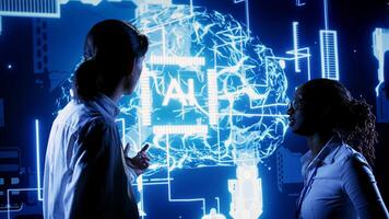 African american engineer and asian coworker looking at hologram of artificial intelligence human brain simulation. BIPOC IT team members interacting with AR AI visualization photo