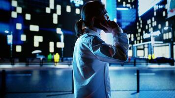 Man strolling around cityscape at night, enjoying conversation over the phone with friends. Businessman walking home from work having telephone call to make commute more enjoyable photo