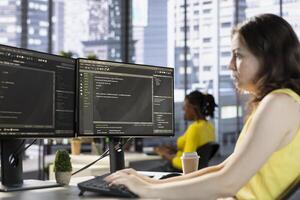 Computer technician working, designing and developing software applications. IT specialist in modern workspace typing on PC keyboard, implementing and maintaining company systems photo