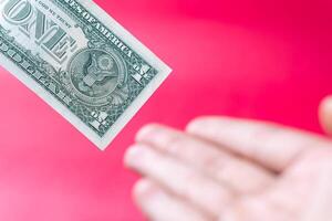 One Dollar Bill in Leather Wallet on Red Background photo