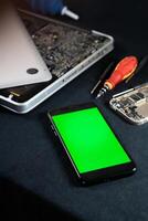 Smart phone with Green Screen in Tech Repair Setting photo