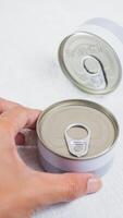 Hand Reaching for a Can with Pull-Tab Lid photo