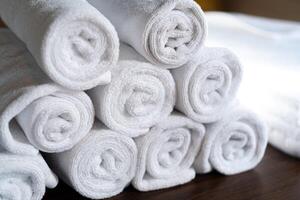 Neatly Stacked White Rolled Towels photo