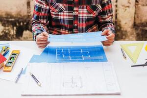 The engineer is giving advice and consulting with the designer to find out the construction site where the engineer will have to construct the project. Consultation between engineers and designers photo
