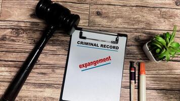 Concept of Criminal Record Expangement write on paperwork isolated on wooden background. photo
