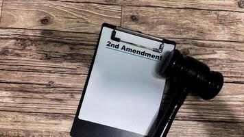 Concept of 2nd Amendment write on paperwork isolated on wooden background. photo