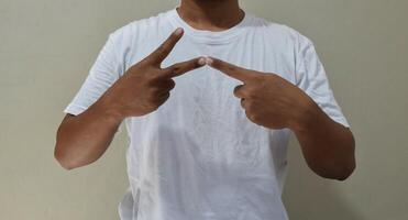 Young man learning and communicating in american sign language photo