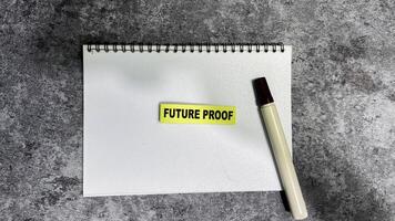 Concept of Future Proof write on sticky notes isolated on Wooden Table. photo