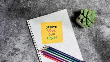 Concept of Create Your Own Future write on sticky notes isolated on Wooden Table. photo