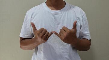 Young man learning and communicating in american sign language photo