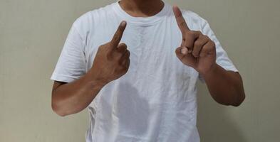 Young man learning and communicating in american sign language photo