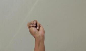 Finger spelling letter M in american sign language photo