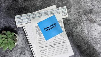 Concept of Qualitative Research write on sticky notes isolated on Wooden Table. photo