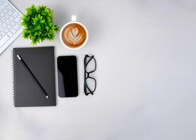 Top view of mock up modern workspace with blank screen smartphone, Keyboard, Coffee cup, Notebook, Glasses. Office situation with keyboard and accessories isolated on white. Copy space, Flat lay. photo