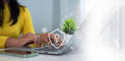 Cybersecurity and Global network security technology concept, Businesswoman protecting personal data on computer with virtual interface, Internet secure technology, Cyber security. photo
