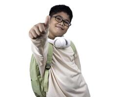 Portrait of boy in casual clothes carry a green bag and white headphones isolated on a white background, The concept of education and way of life. Cute boy posing in casual clothes with clipping part. photo