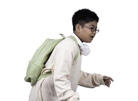 Portrait of boy in casual clothes carry a green bag and white headphones isolated on a white background, The concept of education and way of life. Cute boy posing in casual clothes with clipping part. photo