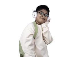 Portrait of boy in casual clothes carry a green bag and white headphones isolated on a white background, The concept of education and way of life. Cute boy posing in casual clothes with clipping part. photo