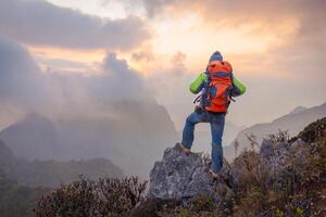 Man hiker on a top of a mountain, hiking in mountains photo