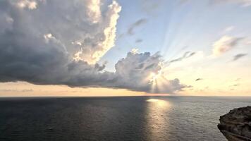Timelapse fluffy Cumulus clouds moving in bright sunset sky over calm sea. Abstract aerial nature summer ocean sunset, sea and sky view. Vacation, travel, holiday concept. Weather and Climate Change video