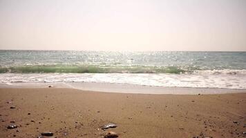 Abstract nature summer ocean sunset sea background. Small waves on water surface in motion blur with bokeh lights from sunrise. Holiday, vacation and recreational background concept. Slow motion video