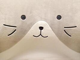 Soft Pillowcase Fabric Texture in the Shape of a Cute cat's Face in Gray photo