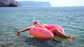 Woman Inflatable Float Sea Relaxing on Pink Flamingo Float in Ocean video