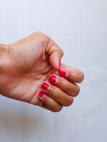 Asian woman hand showing her nail polish isolate on white photo
