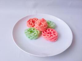 colorful crackers on a plate isolate on white photo