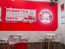 Surabaya, Indonesia - September 24, 2024 Mixue Ice Cream Tea is a chain of ice cream and tea stores that launched a new brand image, Snow King as its brand icon. photo