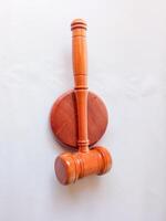 Judge's gavel hammer for adjudication isolated on white background. wooden auction hammer with a wooden stand. law and justice concept. photo