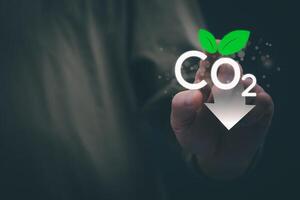 Ideas for reducing carbon emissions or using carbon credits for organizations. Businessman showing carbon credit and green business environmental conservation sustainable environmental development photo
