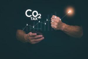 Ideas for reducing carbon emissions Businessman showing carbon tax collection graph and environmental conservation, green business, sustainable environmental development. photo