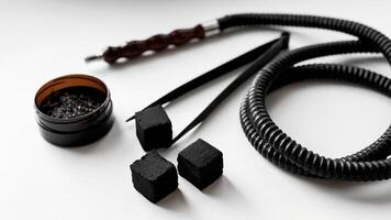 Hookah essentials. charcoal cubes, hose, and accessories on white background photo