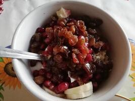 A delightful spread features savory mutton, tender chicken, flavorful daal, and a steaming cup of tea, complemented by an assortment of dry fruits for a touch of sweetness and texture. photo