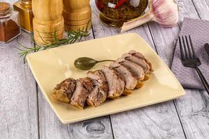 Roasted duck breast slices in the plate photo