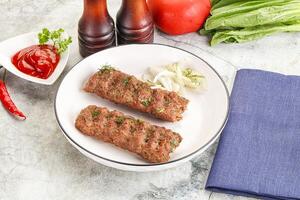 Kebab with beef served onion photo