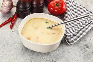 Salmon cream soup with vegetables photo
