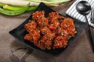 Manchurian chicken with sauce and spices photo