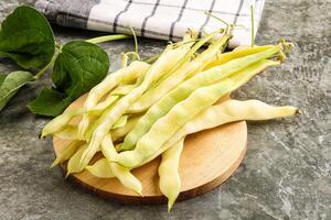 Raw green bean strings heap photo