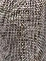 Close-up of stainless steel wire mesh. Woven in regular pattern, shiny metallic, reflecting light. Commonly used in various applications, including construction, filtration, and manufacturing. photo