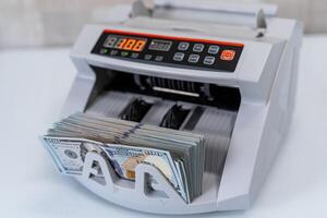 Cropped view of the banking modern counter. Money counting on special machine. Money and business concept photo